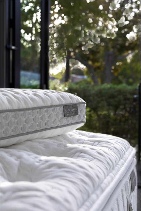 White Aireloom mattress with nature in the background.